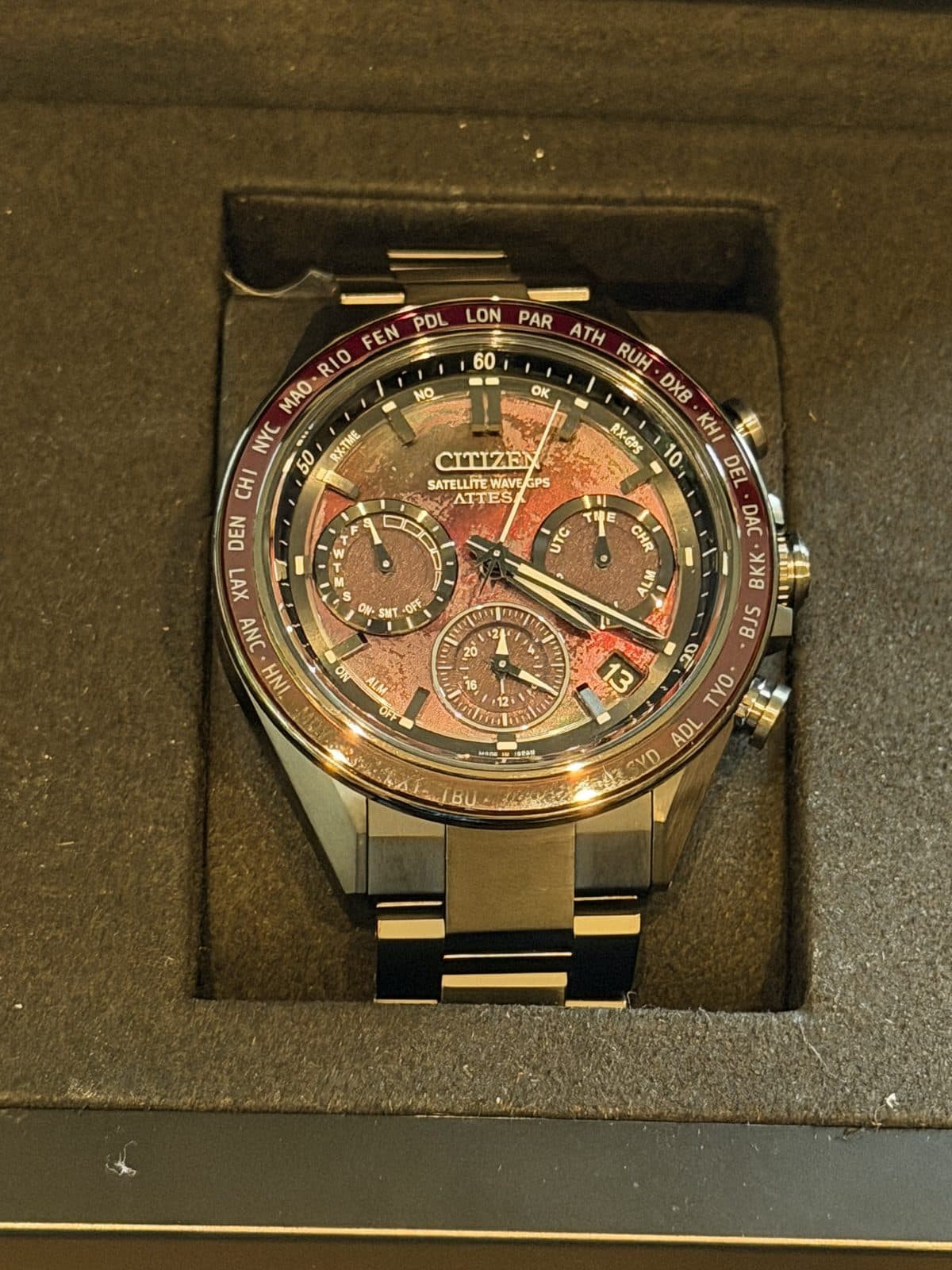 Citizen Attesa Shades of Red CC4077-71Z in its presentation box with the red dial lit